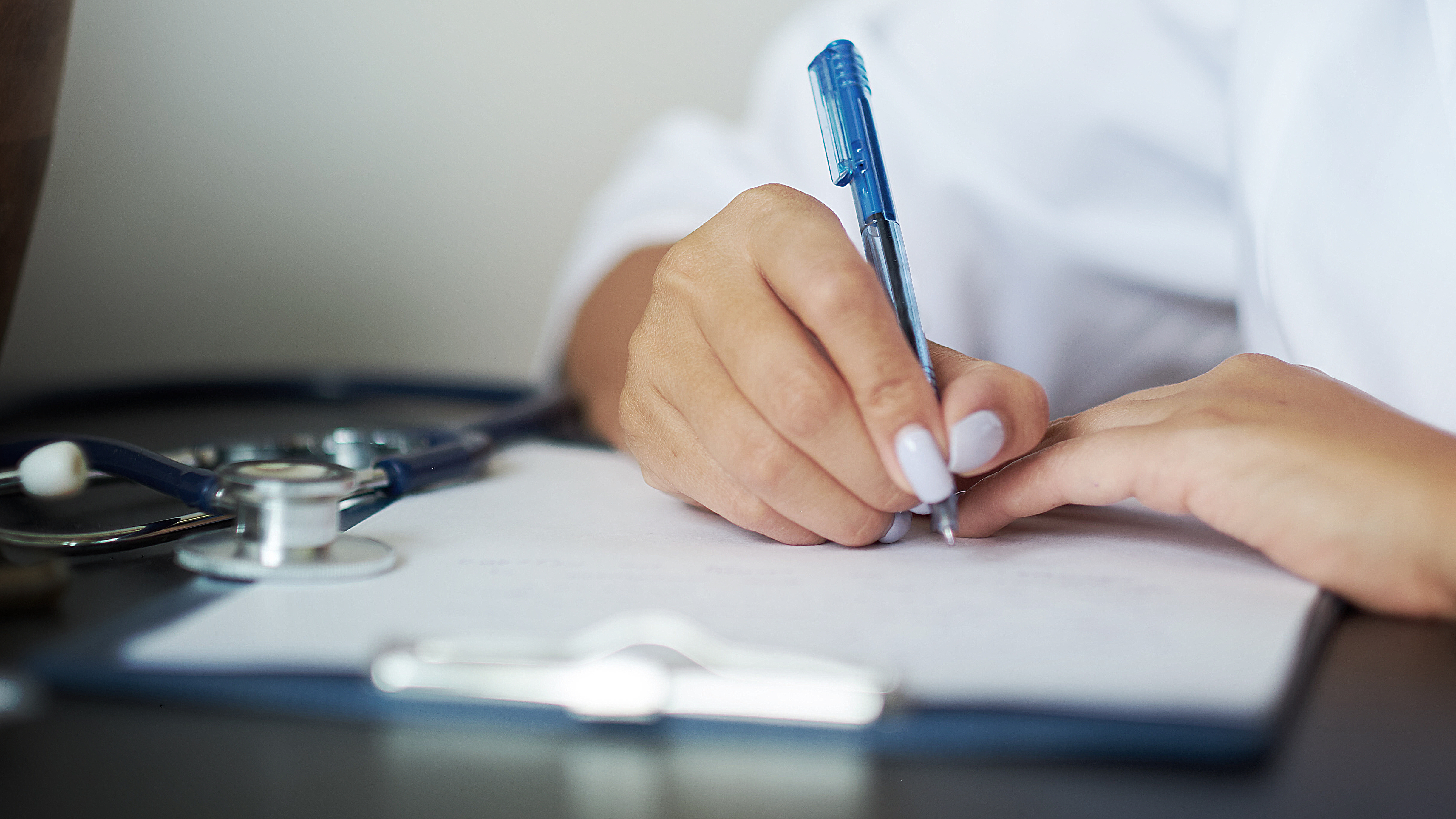 Healthcare professional completing regulatory compliance documentation, representing MDSAP audit preparation and quality management processes