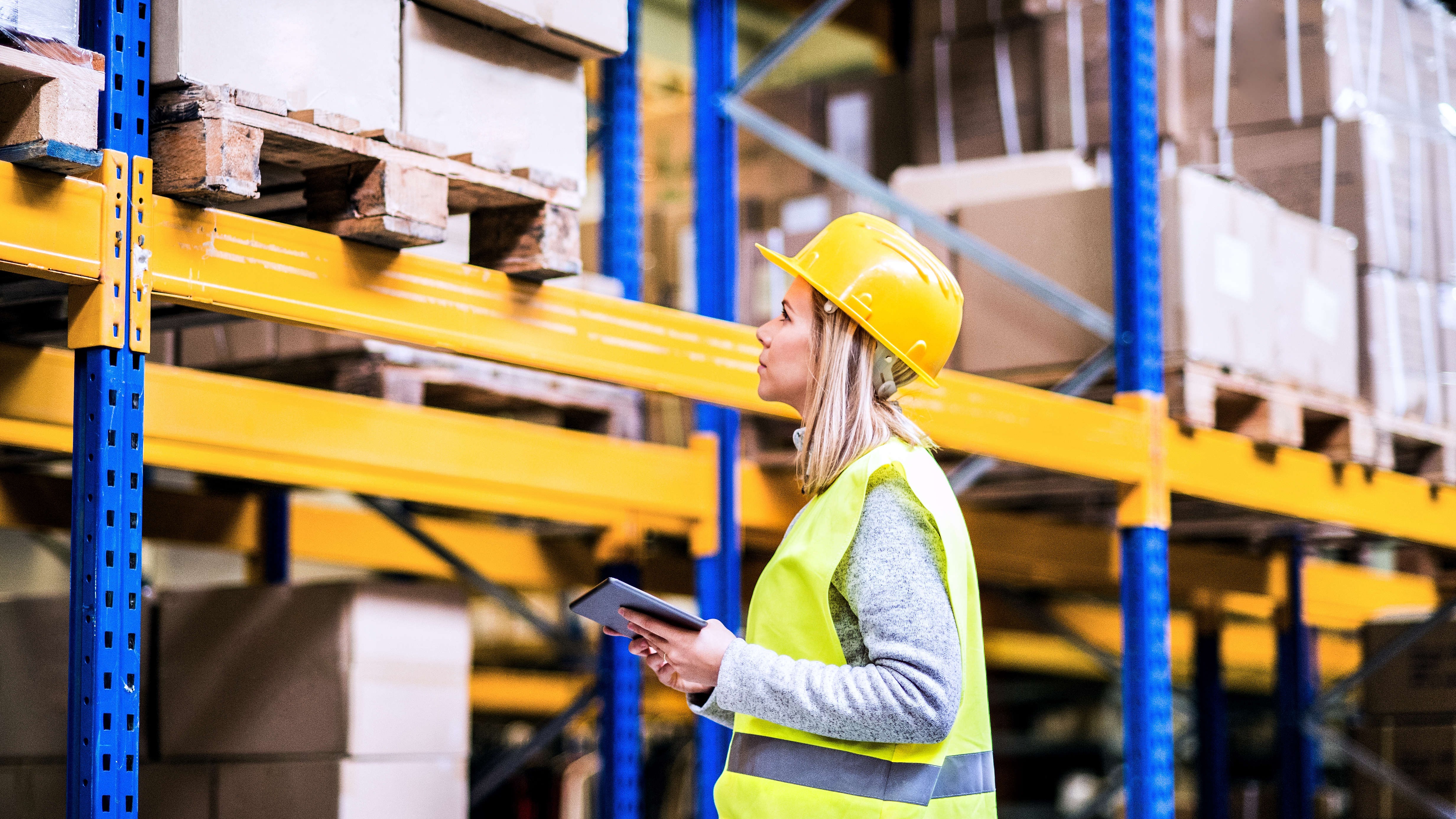 Woman warehouse worker with tablet